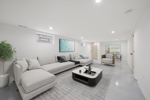 living area with baseboards, finished concrete floors, visible vents, and recessed lighting