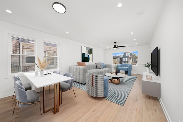 living area with light wood-style flooring, baseboards, a ceiling fan, and recessed lighting