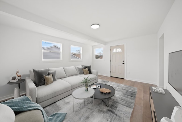 living area featuring light wood-style flooring and baseboards