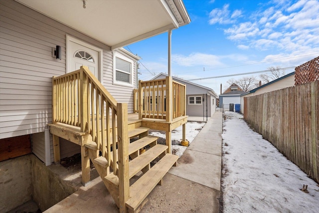 deck with an outbuilding and fence