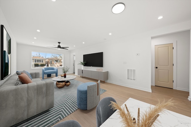 living room featuring recessed lighting, visible vents, and light wood finished floors