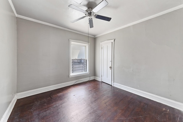 empty room with ornamental molding, wood finished floors, a ceiling fan, and baseboards