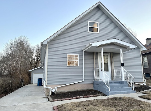 bungalow with a garage and an outbuilding