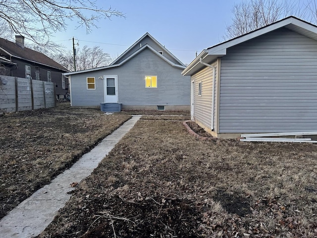 rear view of house with fence