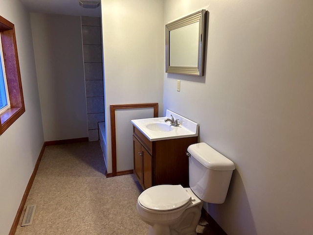 bathroom featuring baseboards, visible vents, toilet, walk in shower, and vanity