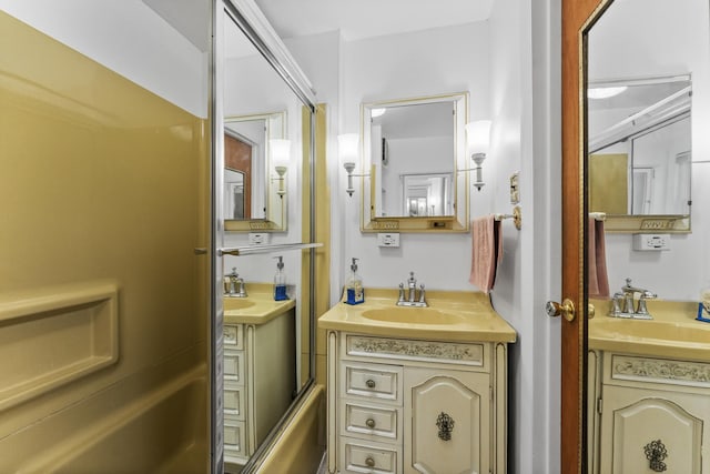 bathroom with shower / bath combination, two vanities, and a sink