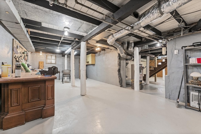 unfinished basement featuring stairs