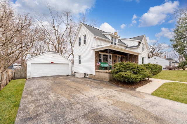 view of side of home featuring an outbuilding, brick siding, a porch, fence, and a garage