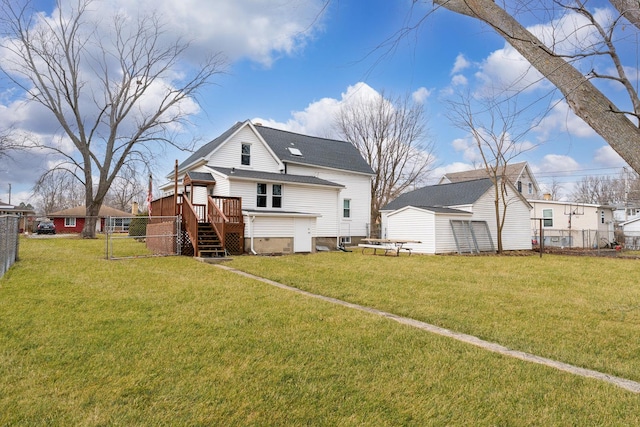 rear view of house featuring a deck, a yard, and fence private yard