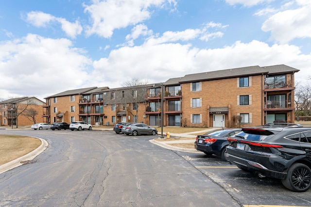 view of building exterior with uncovered parking