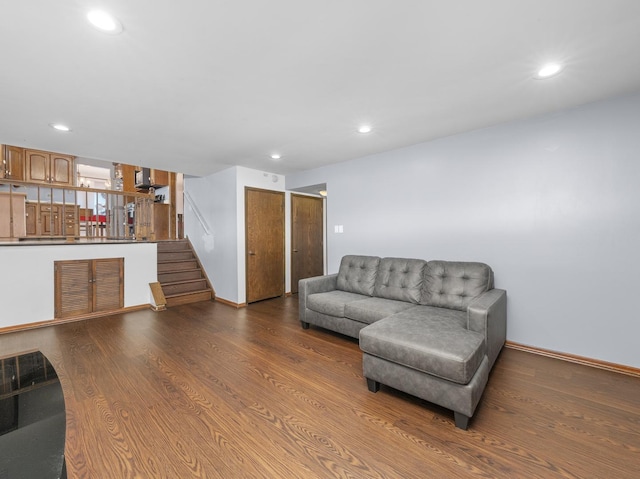 living room with baseboards, visible vents, stairway, wood finished floors, and recessed lighting