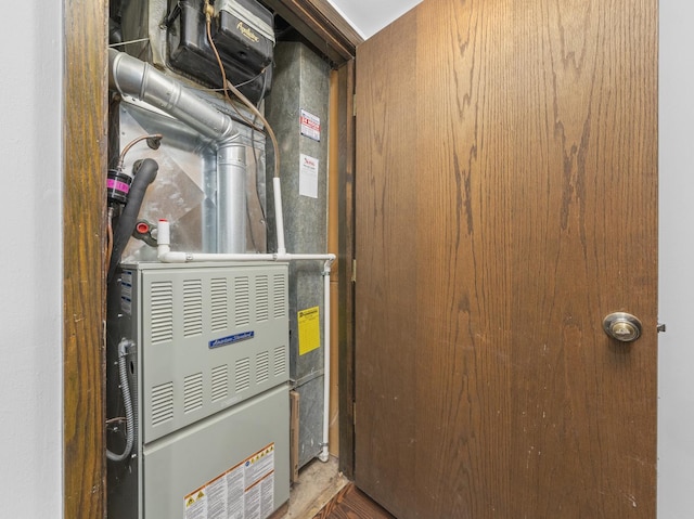 utility room featuring heating unit