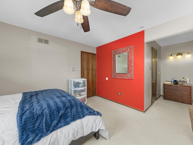 bedroom with carpet floors, ceiling fan, and visible vents