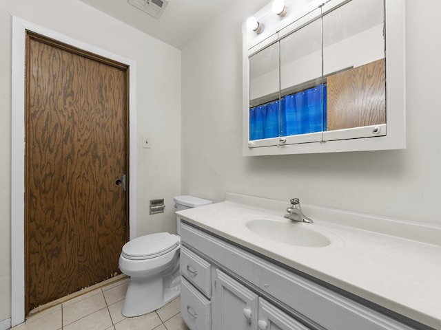 bathroom featuring toilet, vanity, visible vents, and tile patterned floors