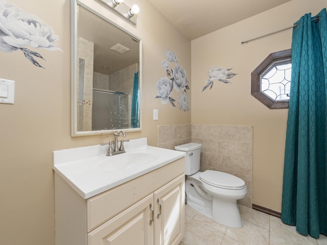 bathroom featuring tiled shower, vanity, toilet, and tile patterned floors