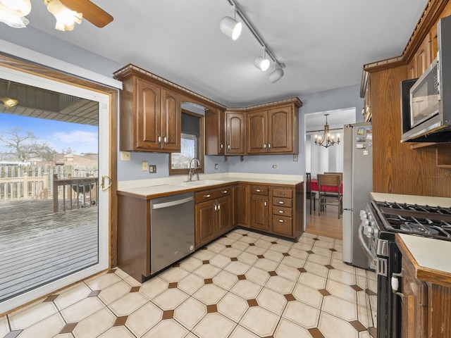 kitchen featuring light floors, stainless steel appliances, a sink, and light countertops