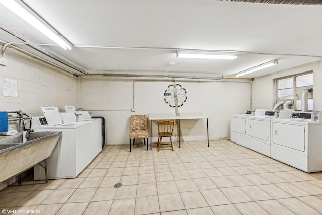 common laundry area with washer and dryer and a sink