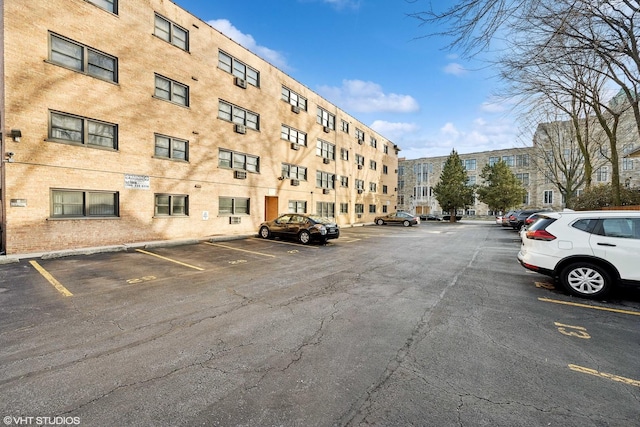 view of building exterior featuring uncovered parking