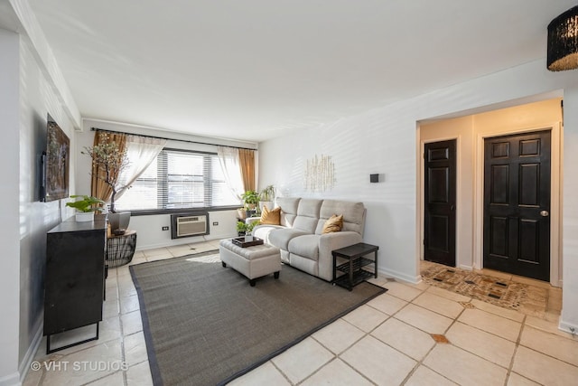 living area with light tile patterned floors, baseboards, and a wall unit AC