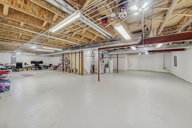 unfinished basement featuring electric panel, water heater, and heating unit