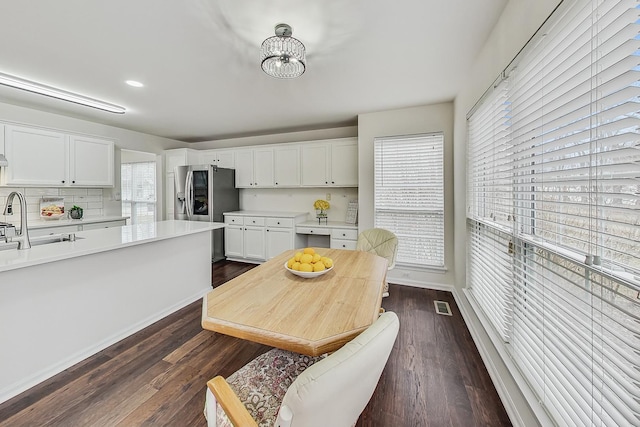 kitchen featuring dark wood-style floors, light countertops, visible vents, and white cabinetry