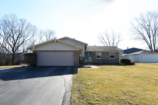 view of front facade featuring a garage, aphalt driveway, a front lawn, and brick siding