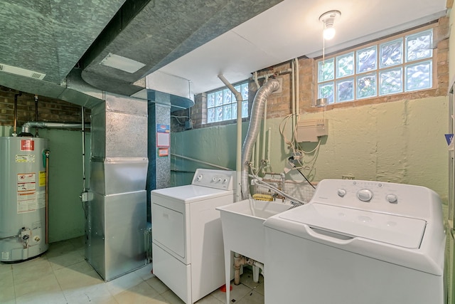 2547 2nd Ave, North Riverside, IL 60546 - laundry area with gas water heater, washing machine and dryer, and light tile patterned floors