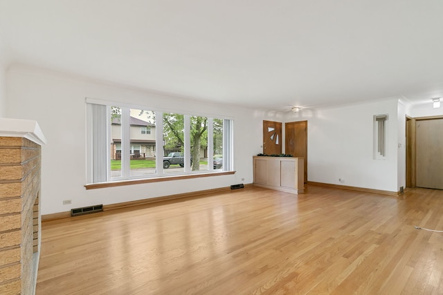 2547 2nd Ave, North Riverside, IL 60546 - unfurnished living room featuring light wood-style flooring, ornamental molding, baseboards, and a fireplace