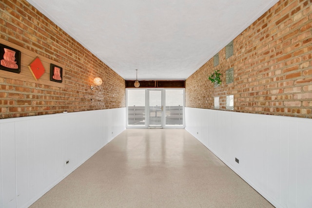 2547 2nd Ave, North Riverside, IL 60546 - spare room with a wainscoted wall and brick wall