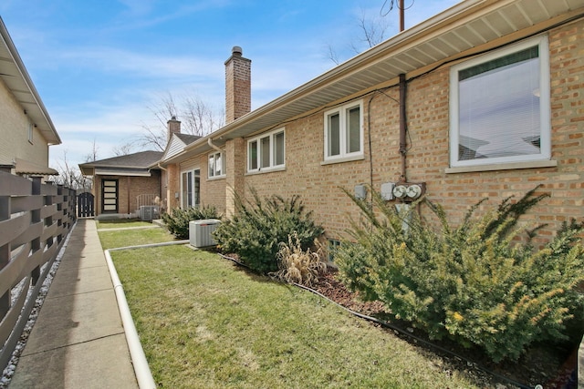 2547 2nd Ave, North Riverside, IL 60546 - view of side of property featuring a chimney, central AC unit, and brick siding