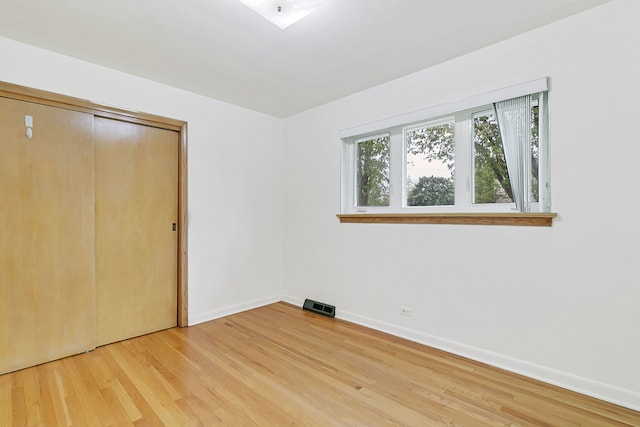 2547 2nd Ave, North Riverside, IL 60546 - unfurnished bedroom with light wood-style floors, baseboards, and a closet