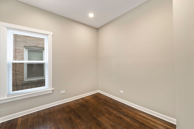 spare room with dark wood-style floors, baseboards, and recessed lighting