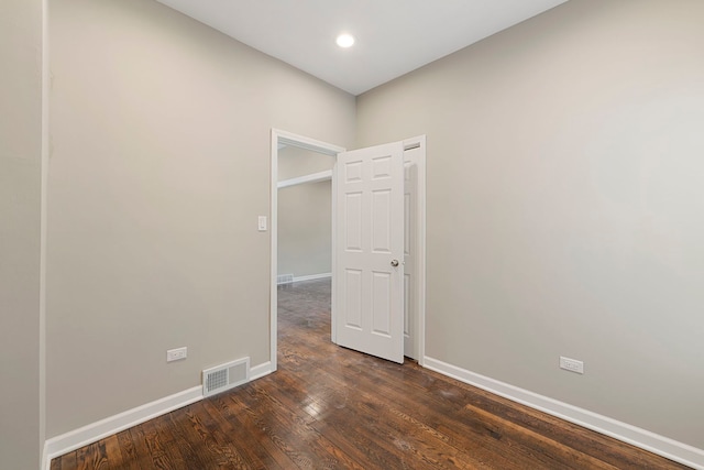 empty room featuring recessed lighting, visible vents, baseboards, and hardwood / wood-style flooring