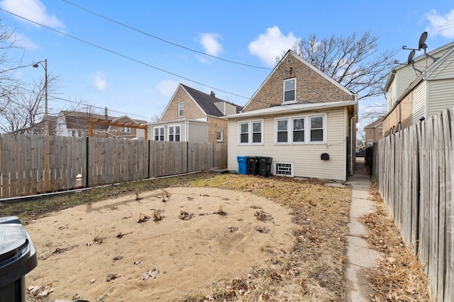 back of property featuring a fenced backyard