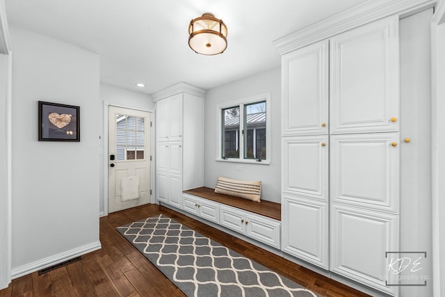 mudroom featuring dark wood-style floors, baseboards, visible vents, and recessed lighting