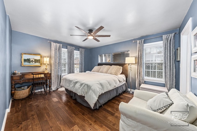 bedroom featuring hardwood / wood-style flooring, ceiling fan, and multiple windows