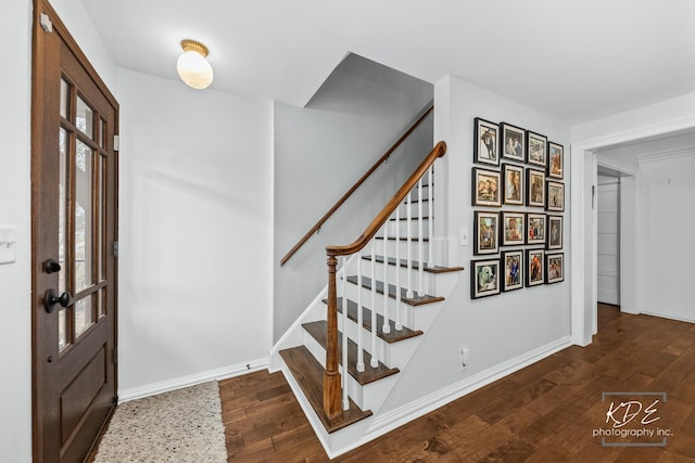 entryway featuring hardwood / wood-style floors, stairway, and baseboards