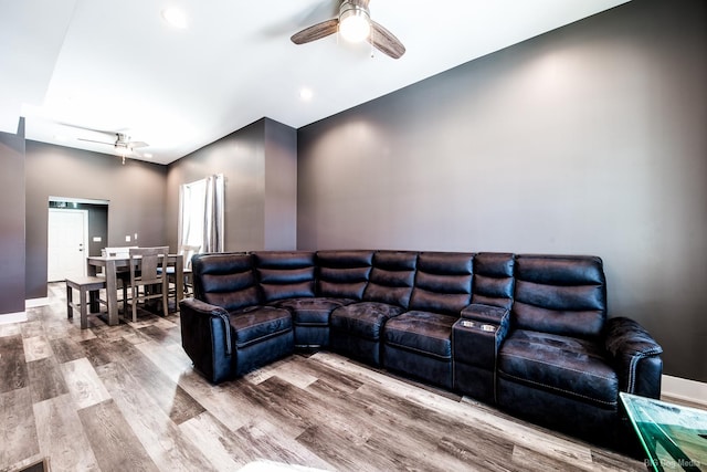 living room featuring a ceiling fan and wood finished floors