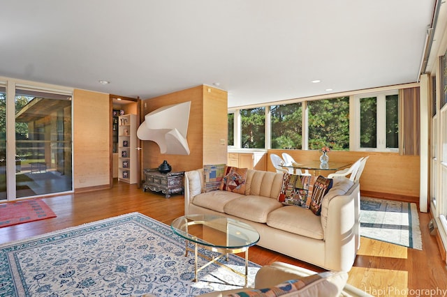 living area featuring expansive windows, recessed lighting, and wood finished floors