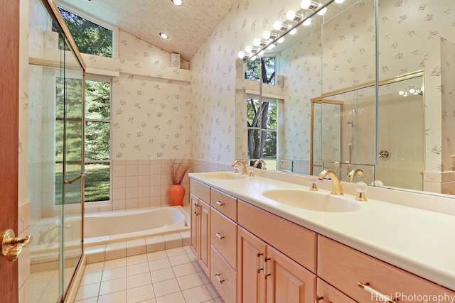 bathroom with lofted ceiling, tile patterned flooring, a sink, and wallpapered walls