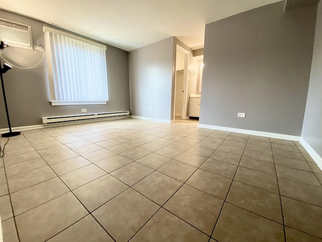 spare room featuring a baseboard radiator, a wall mounted AC, baseboards, and tile patterned floors