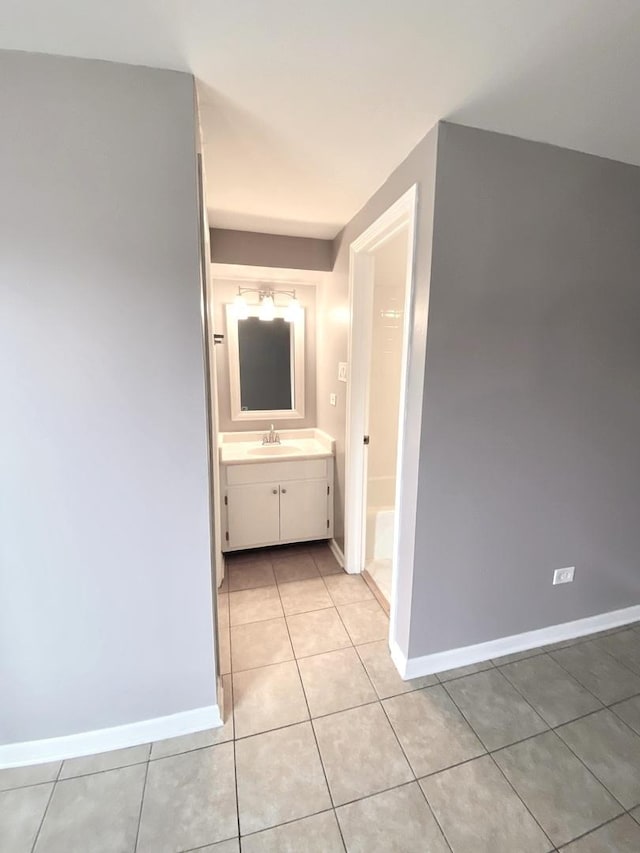 bathroom featuring tile patterned flooring, vanity, and baseboards