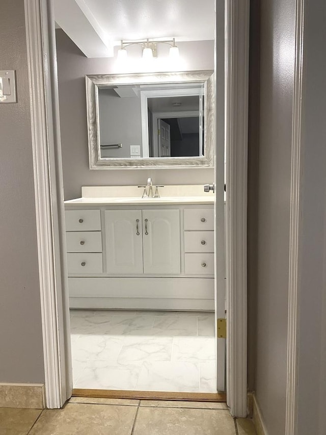 bathroom with marble finish floor and vanity