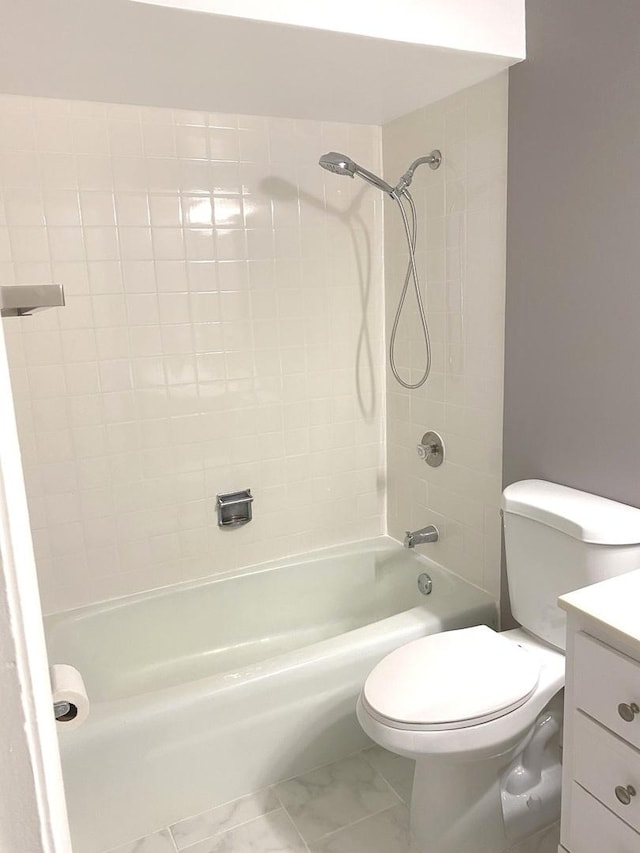 bathroom with toilet, marble finish floor, tub / shower combination, and vanity