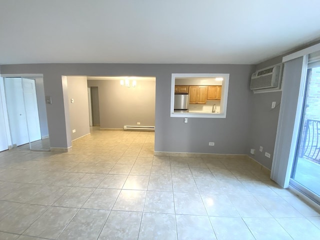 unfurnished room featuring light tile patterned floors, baseboards, baseboard heating, a notable chandelier, and a wall mounted AC