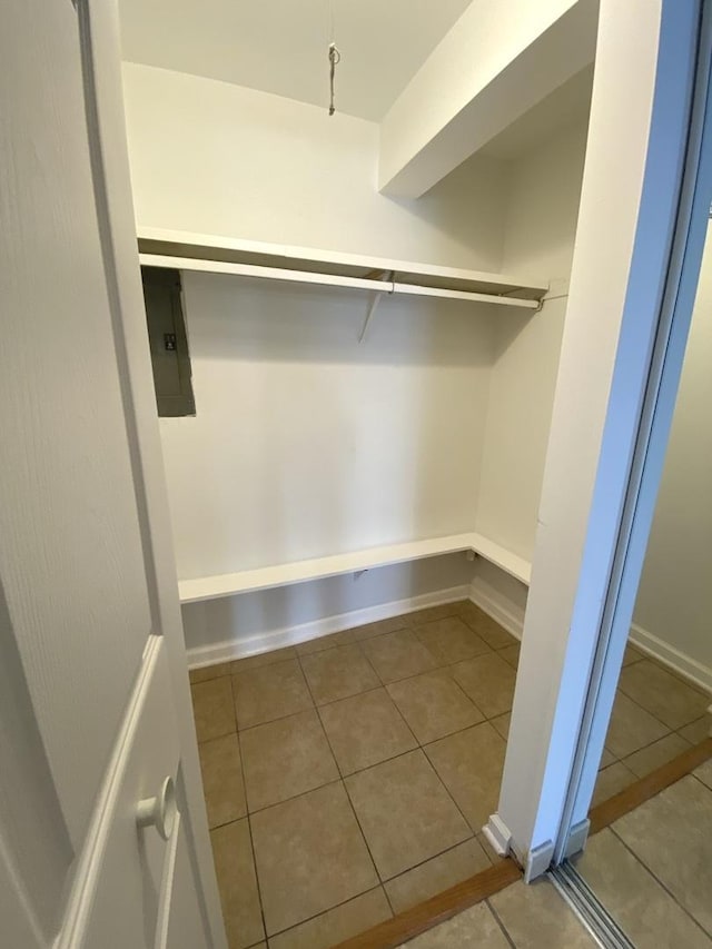 spacious closet featuring tile patterned flooring and electric panel