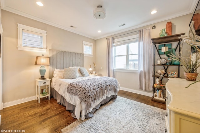 bedroom featuring baseboards, dark wood-style floors, visible vents, and ornamental molding