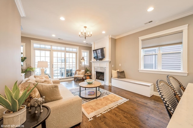 living room with recessed lighting, visible vents, wood finished floors, and crown molding