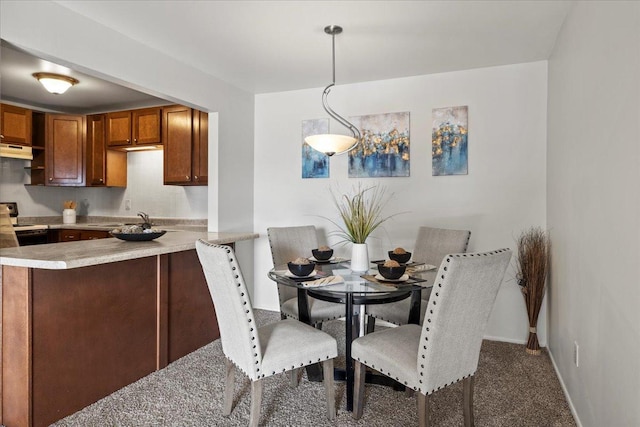 kitchen featuring white electric stove, a sink, light countertops, carpet, and decorative light fixtures