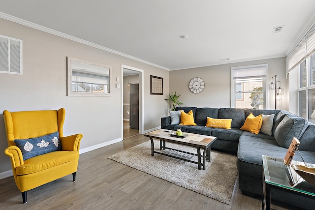 living room featuring baseboards, visible vents, wood finished floors, and ornamental molding